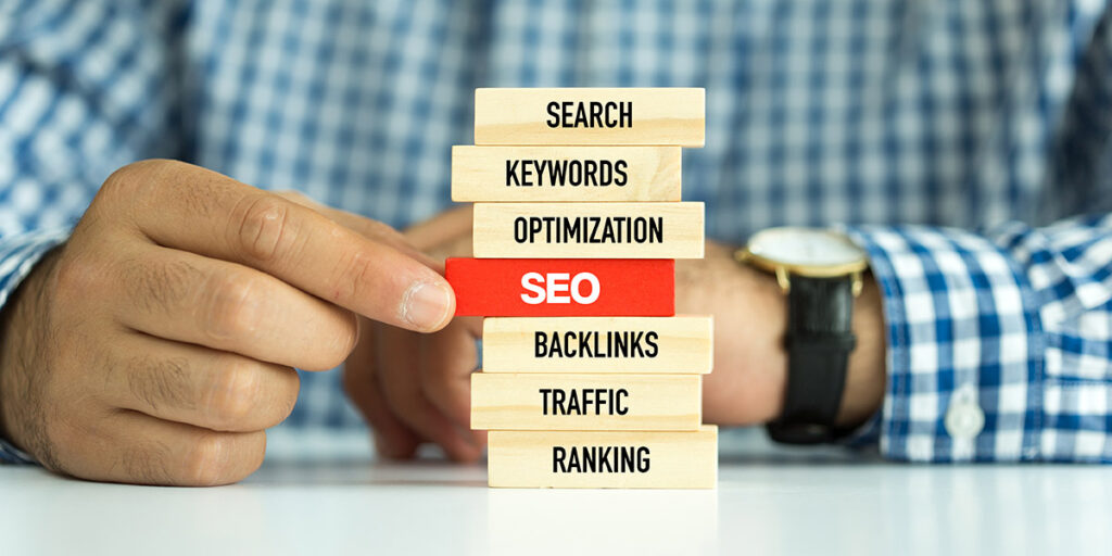 SEO concept with blocks, representing steps involved to optimize website for search engines, such as optimized keywords and backlinks.
